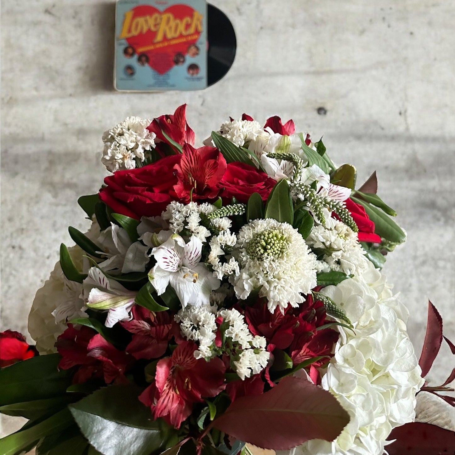 Handcrafted rose bouquet with delicate orchids and eucalyptus, symbolizing eternal love and admiration.