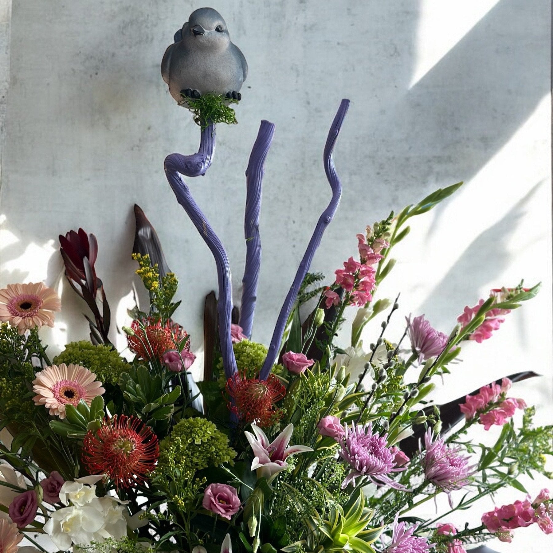 Classic sympathy flower basket featuring white lilies, hydrangeas, and soft greenery, offering warmth and condolence.