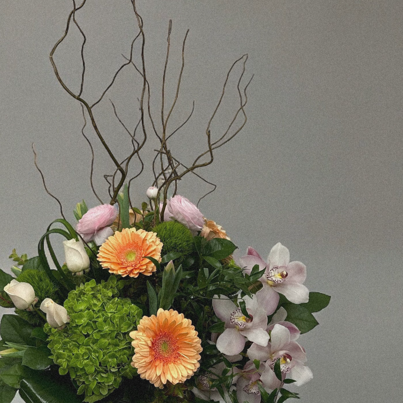 Pastel-colored spring bouquet featuring soft pink peonies, roses, and delicate filler flowers.