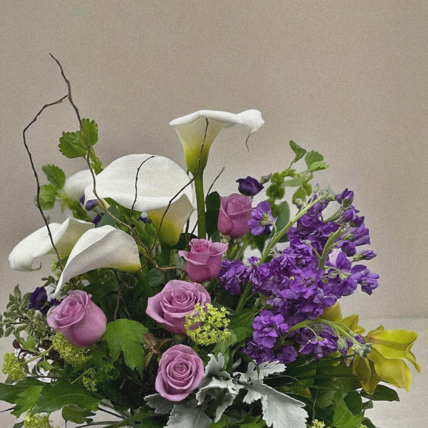 Chic luxury floral arrangement with calla lilies, roses, and purple blooms. Perfect for all occasions. Best florist in Toronto and GTA.