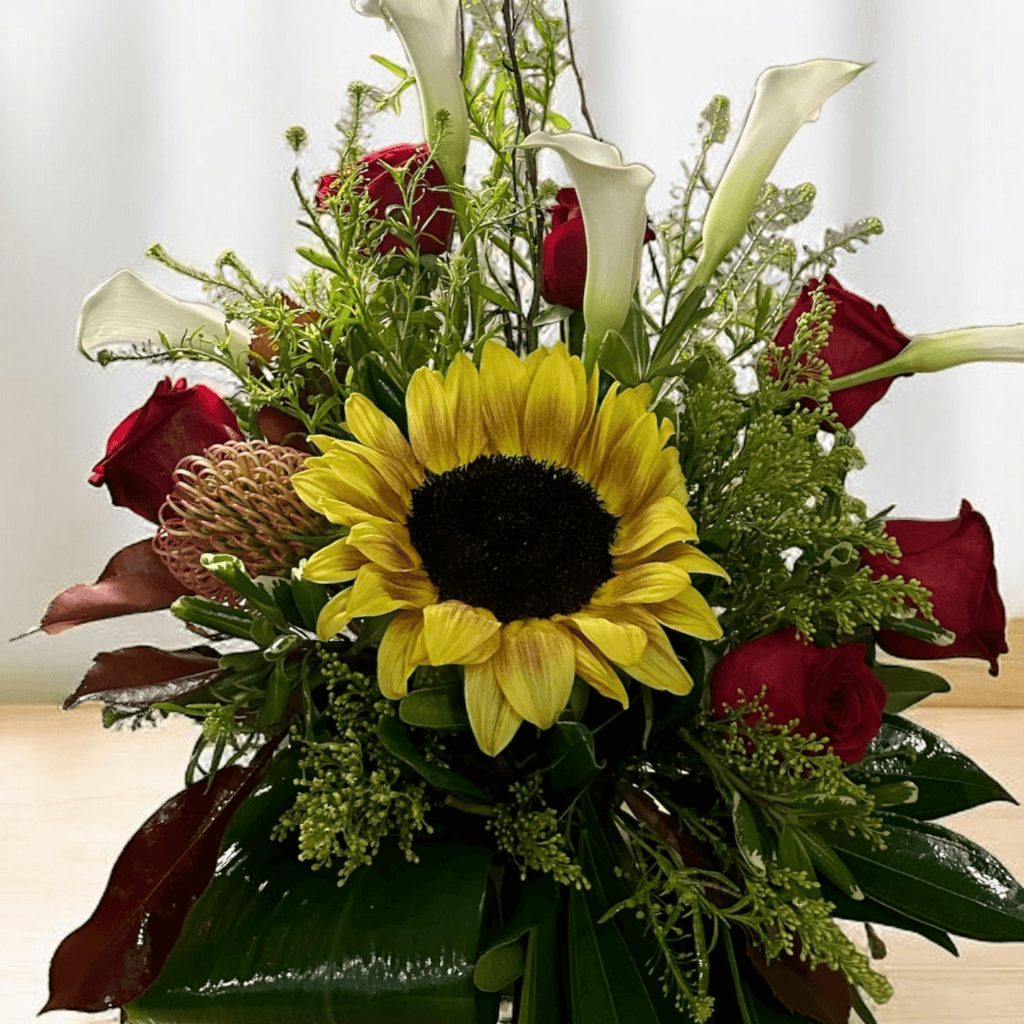 Sunlit Romance luxury floral arrangement with sunflower, red roses, calla lilies, ideal for expressing love. Best Toronto florist, same day delivery
